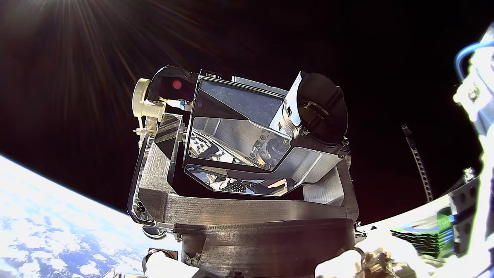 Muon-Managed-Orbital-Services-Starlink-Image A Starlink satellite component in low Earth orbit with Earth's curved horizon and sunlight visible in the background.